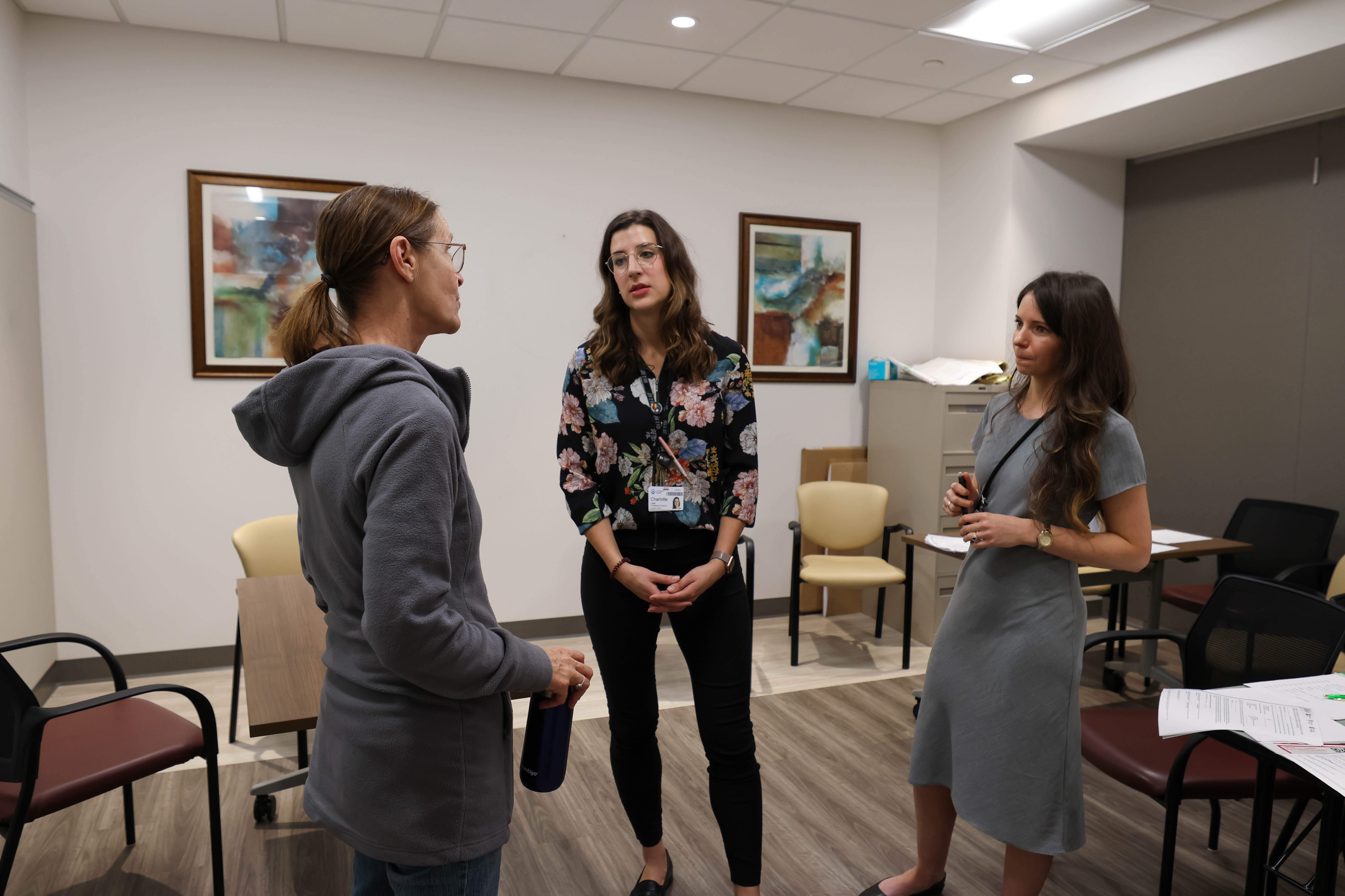 The simulation actor, Charlotte and Meghan debrief after a simulation.