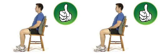 A man sitting in a chair with his back against a lumbar cushion