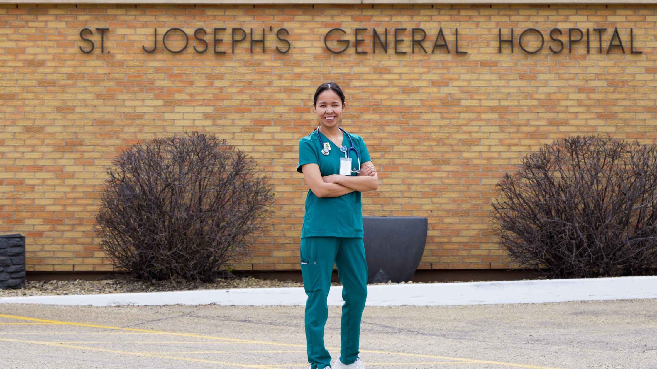 Makayla Mantla standing with her arms crossed in front of St. Joseph's General Hospital
