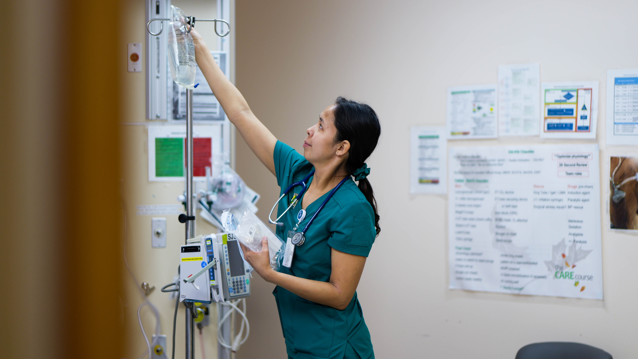 Makayla Mantla setting up an IV drip in a health care treatment room.