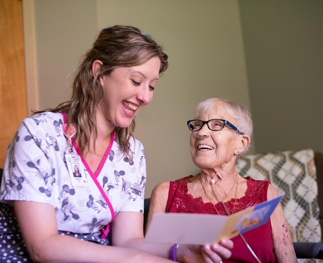 A student interacts with a resident in a long-term care centre.