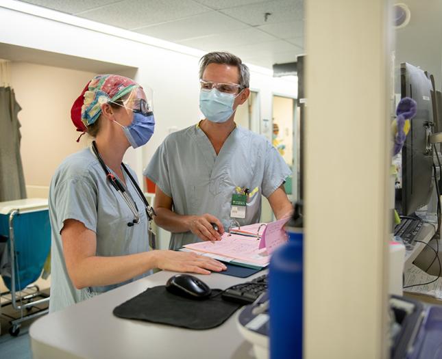Covenant Health staff review a patient file together.