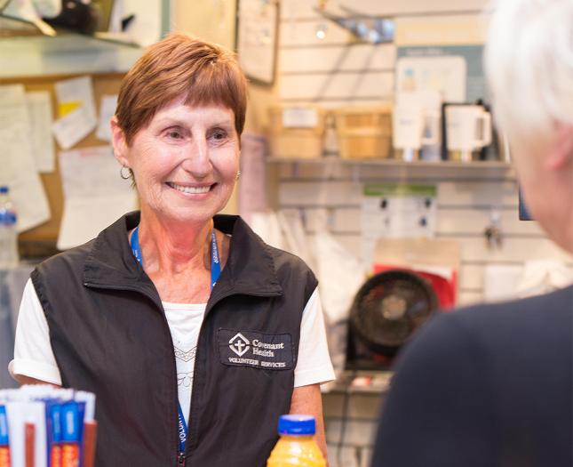 A volunteer working in a gift shop