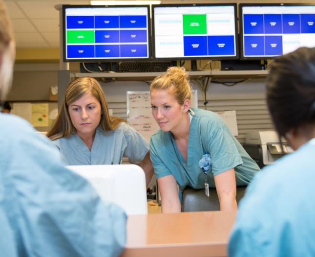 Four health professionals interacting in a health care setting