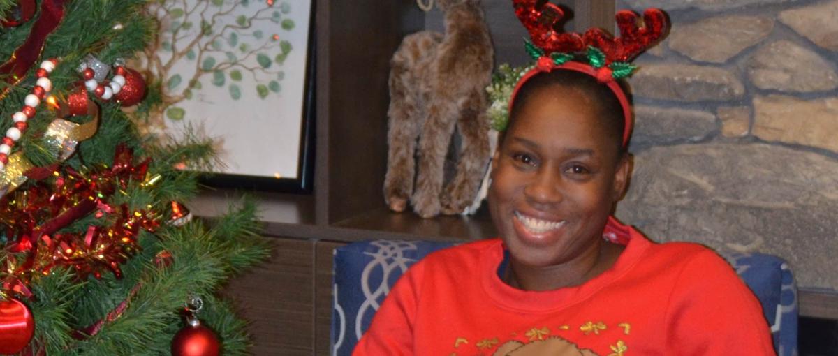 Allison Sinclair-Graham sits among festive holiday decorations