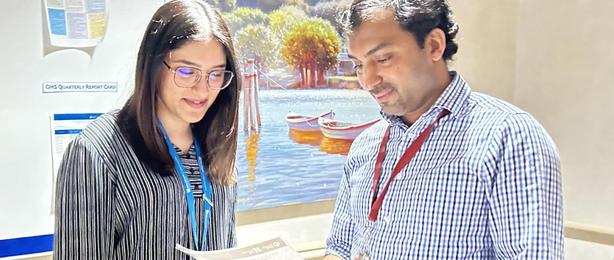 A man and woman examining a printed report together