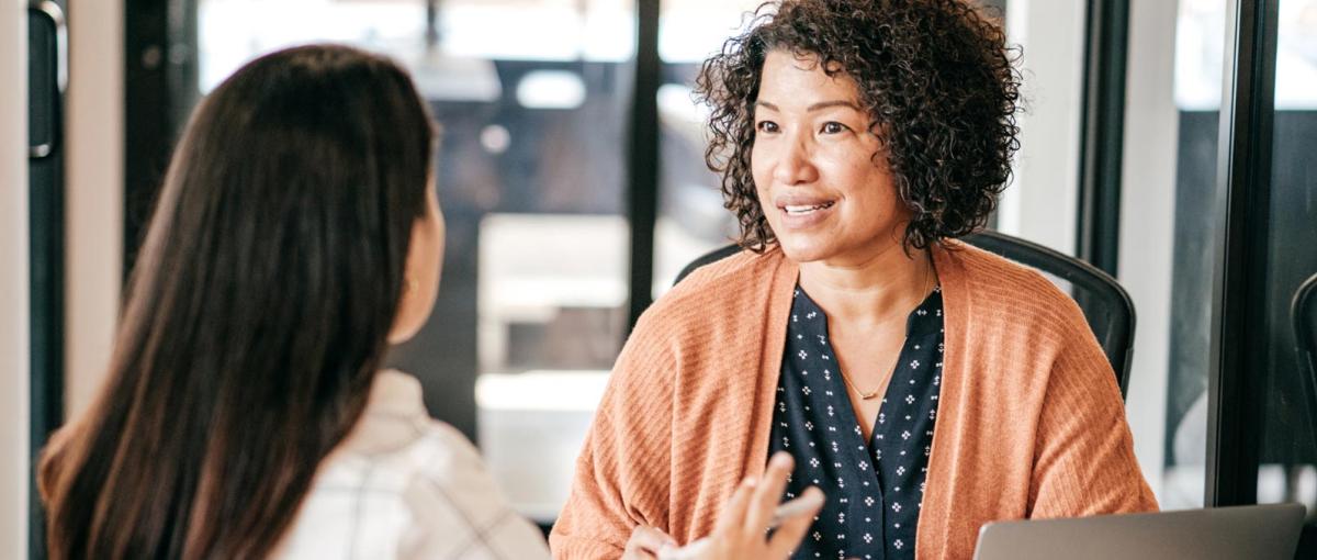 Two people engaged in conversation in an office setting