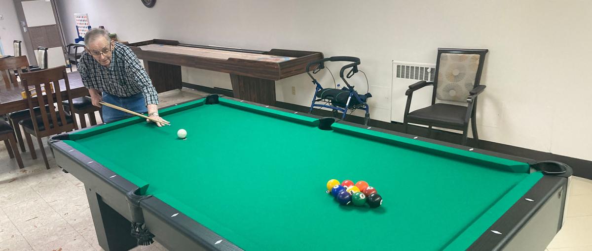 Elmer Stabler uses the pool table at Covenant Health facility in Medicine Hat.