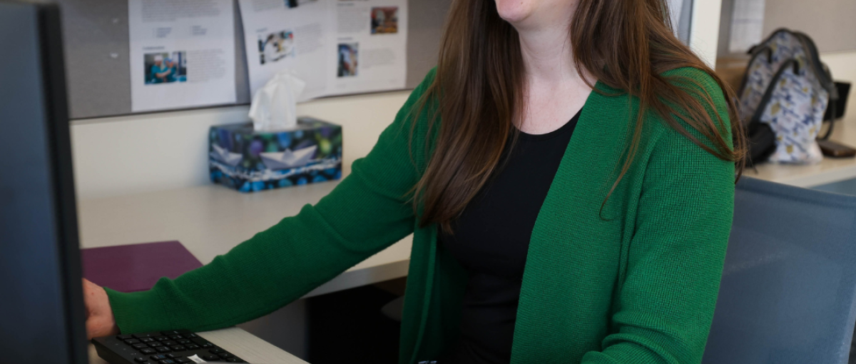 Trisha Tallon, manager of organizational development and effectiveness for Covenant Health, poses at her desk where she developed the Menopause Matters program.