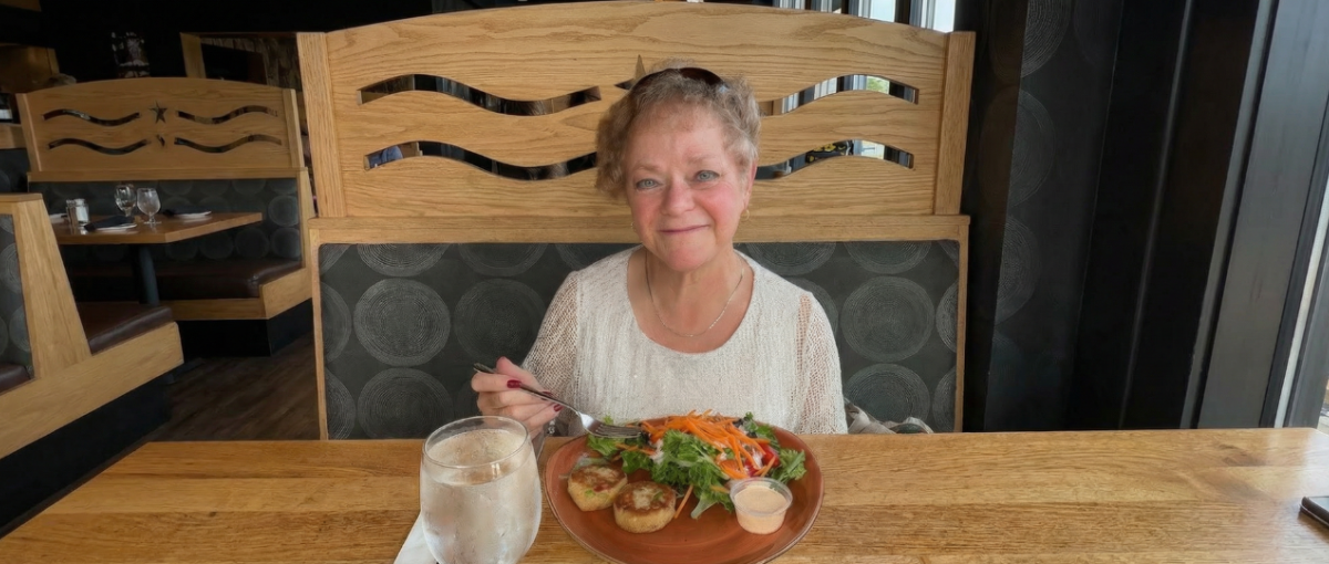 Volunteer Kathryn Kirby is pictured having dinner at a restaurant.