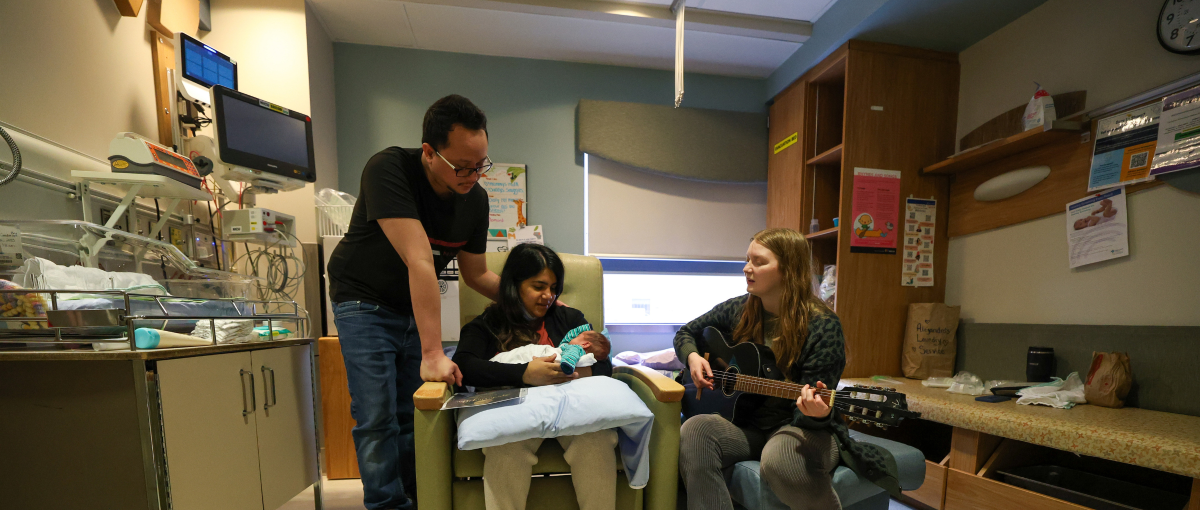 Rebecca Lappe, music therapy student, works with the Amores family on the neonatal intensive care unit at the Grey Nuns Community Hospital.