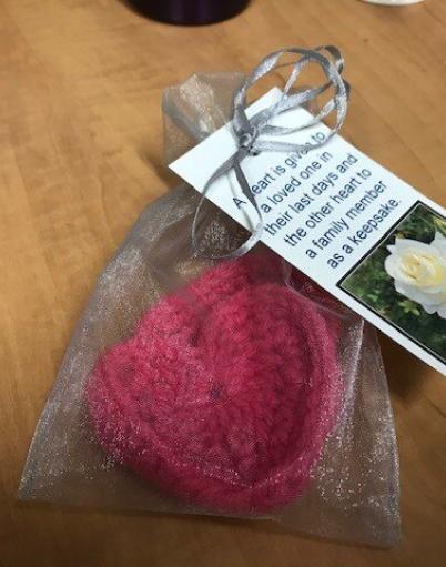 A sewn heart placed in a bag with a personalized note