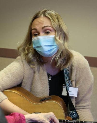 Nadine Verboa plays on her guitar for a resident