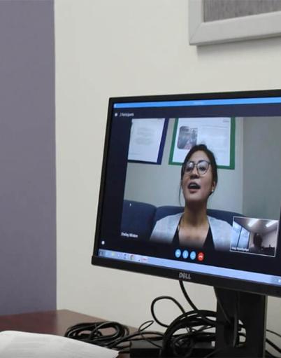 A doctor attends a virtual meeting on his computer