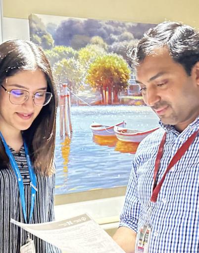 A man and woman examining a printed report together