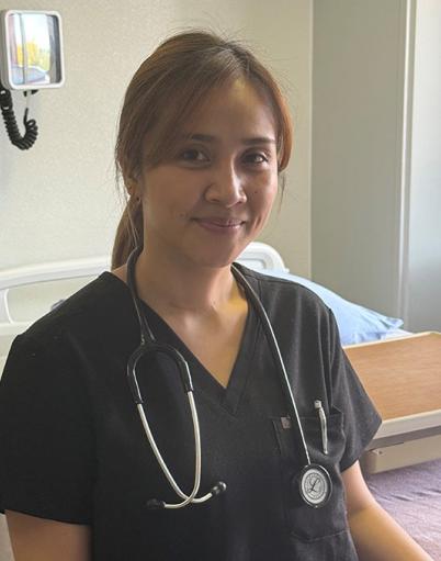 Internationally educated nurse Keren Balagot poses at bedside at St. Mary’s Hospital in Camrose, Alberta.