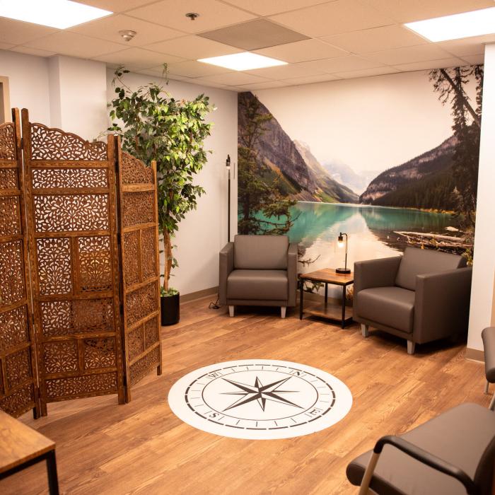 Multifaith room with seating and nature mural
