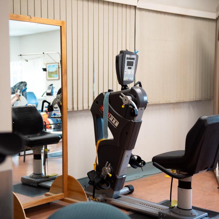 Physical therapy area with exercise equipment and mirrors