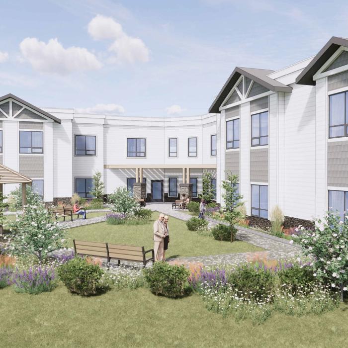 Courtyard of Trochu Supportive Living facility with garden, gazebo, benches, and multi-story building.