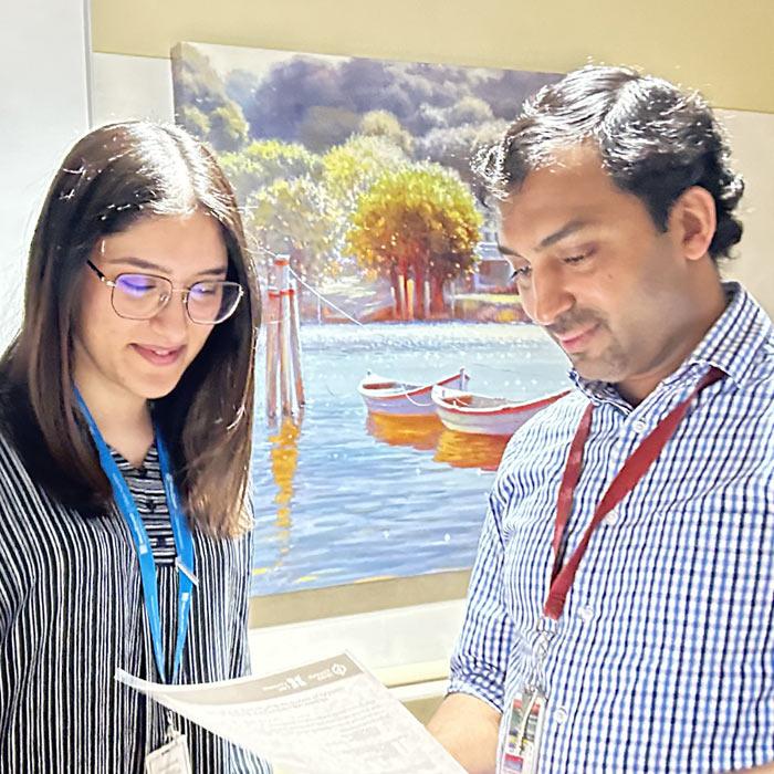 A man and woman examining a printed report together