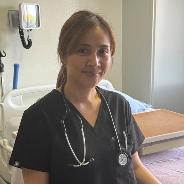 Internationally educated nurse Keren Balagot poses at bedside at St. Mary’s Hospital in Camrose, Alberta.