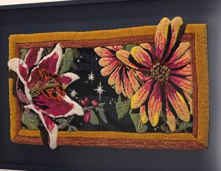 Artwork depicting stargazer lilies and asters created from yarn