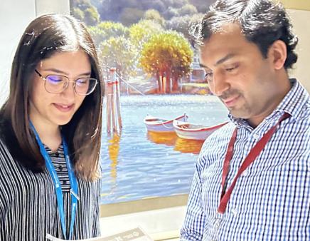 A man and woman examining a printed report together