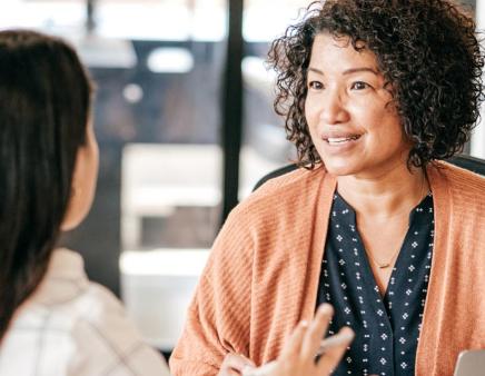 Two people engaged in conversation in an office setting