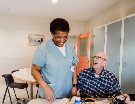 Nurse interacting with elderly patient