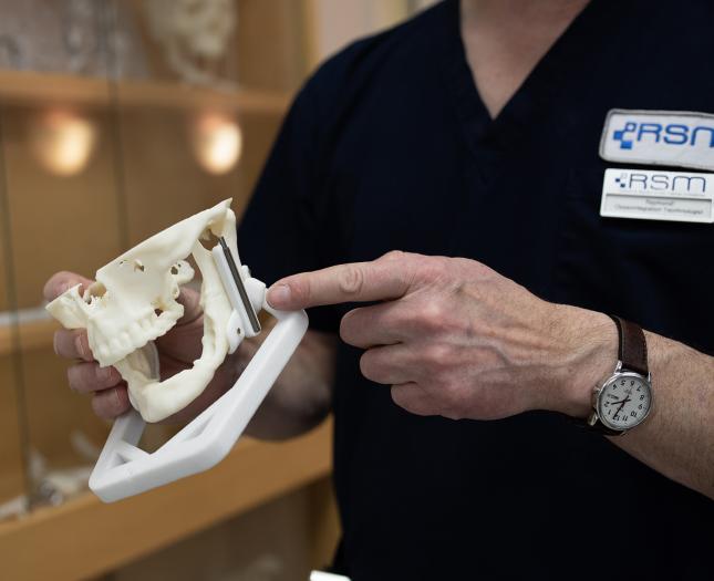 iRSM An iRSM team member holds a model of a jaw.