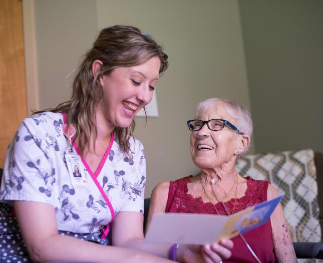 Network of Excellence in Seniors' Health and Wellness A staff member reads to a resident.