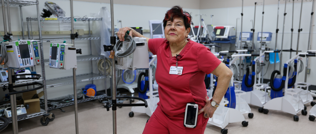 Modesta Caturuzza, porter, shows off the pharmacy carts she transports throughout the hospital.