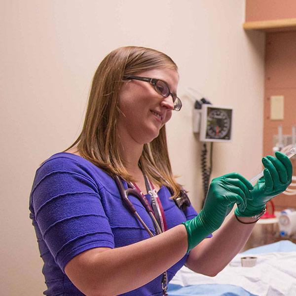 Why work at Covenant Health A staff member with a stethoscope smiles as she works