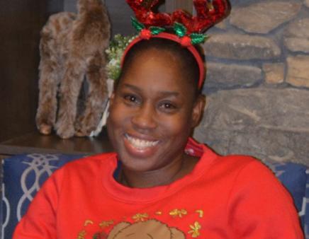 Allison Sinclair-Graham sits among festive holiday decorations